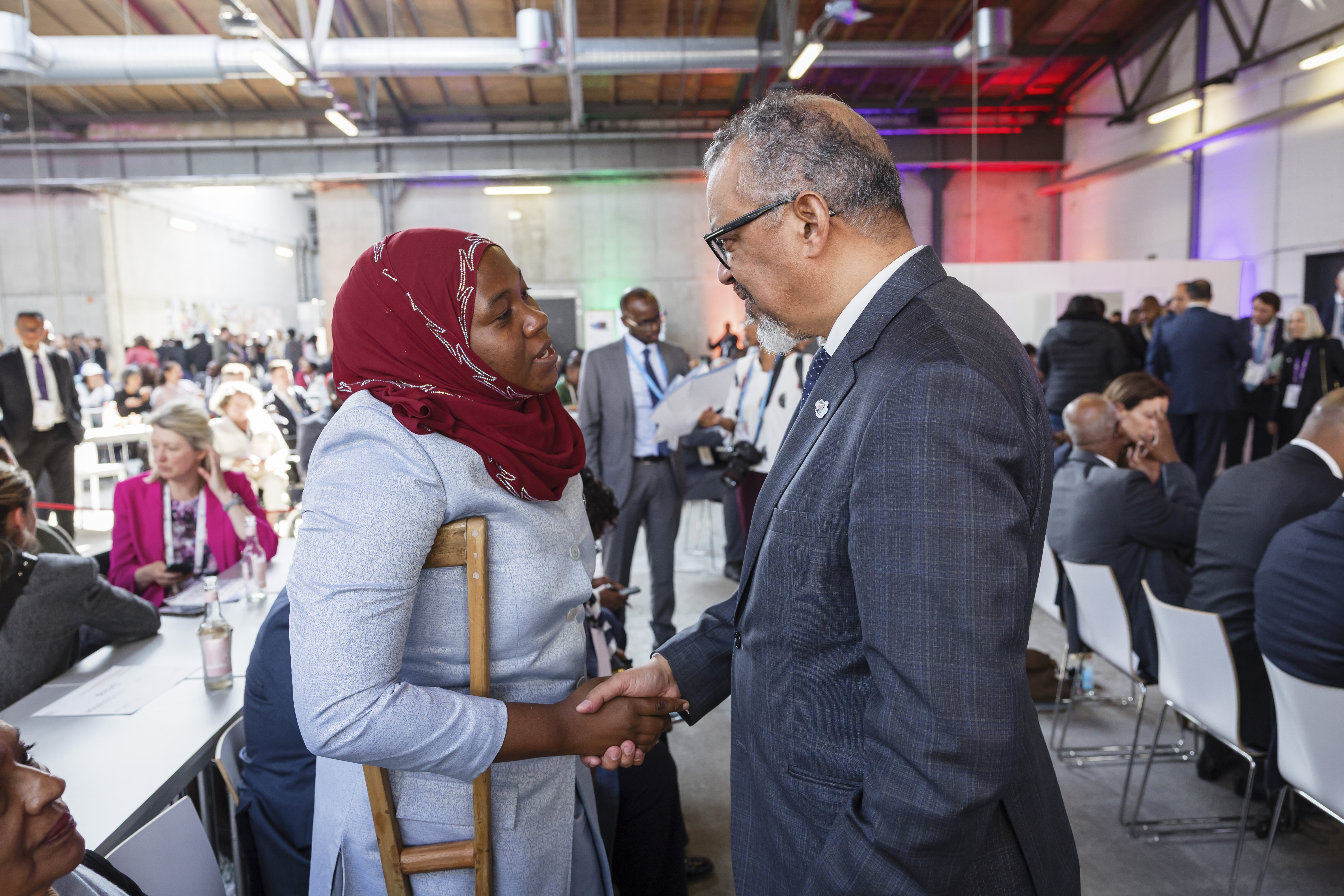 Dr Tedros Adhnanom Ghebreyesus, Director-General, WHO, speaking with a woman with disabilities at the Global Disability Summit