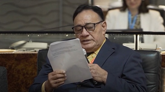Video snapshot of Valasi Luapitofanua To’ogamaga Tafito Selese delivering a speech whilst reading from a script.