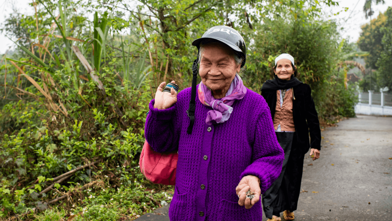 Photo of two elderly Vietnamese women walking to a health appointment.