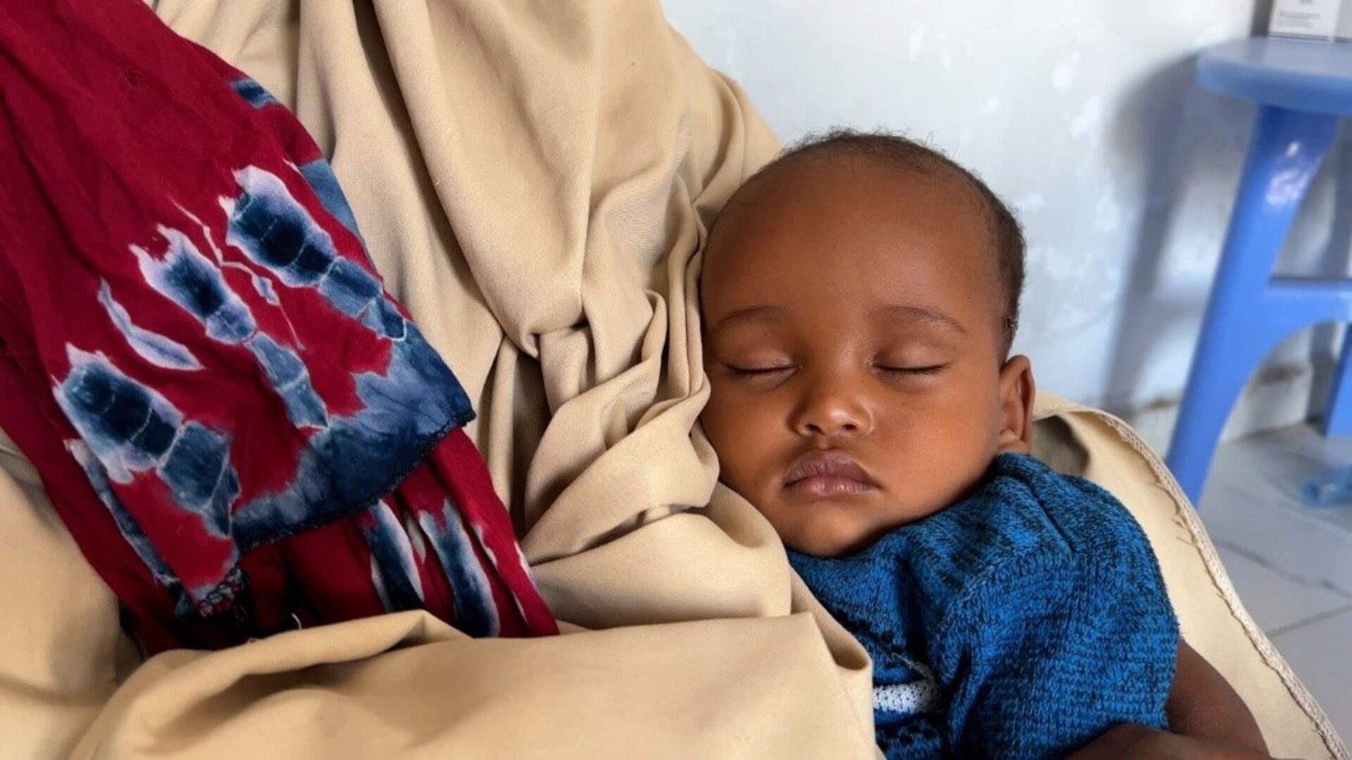 mother holds sleeping baby
