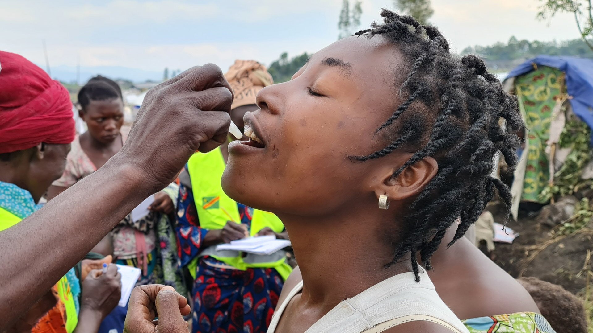 A woman receives a dose of the oral cholera vaccine