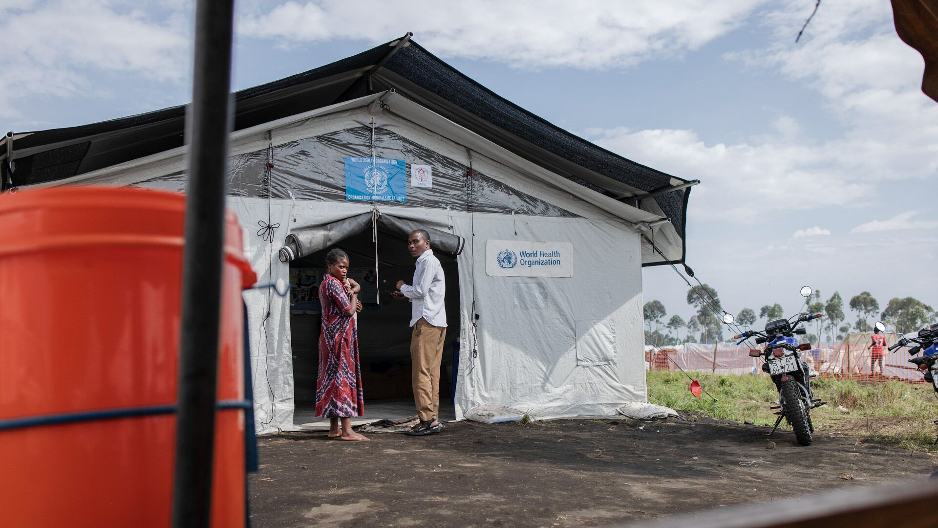 Two people stand at the entrance to a transit health center