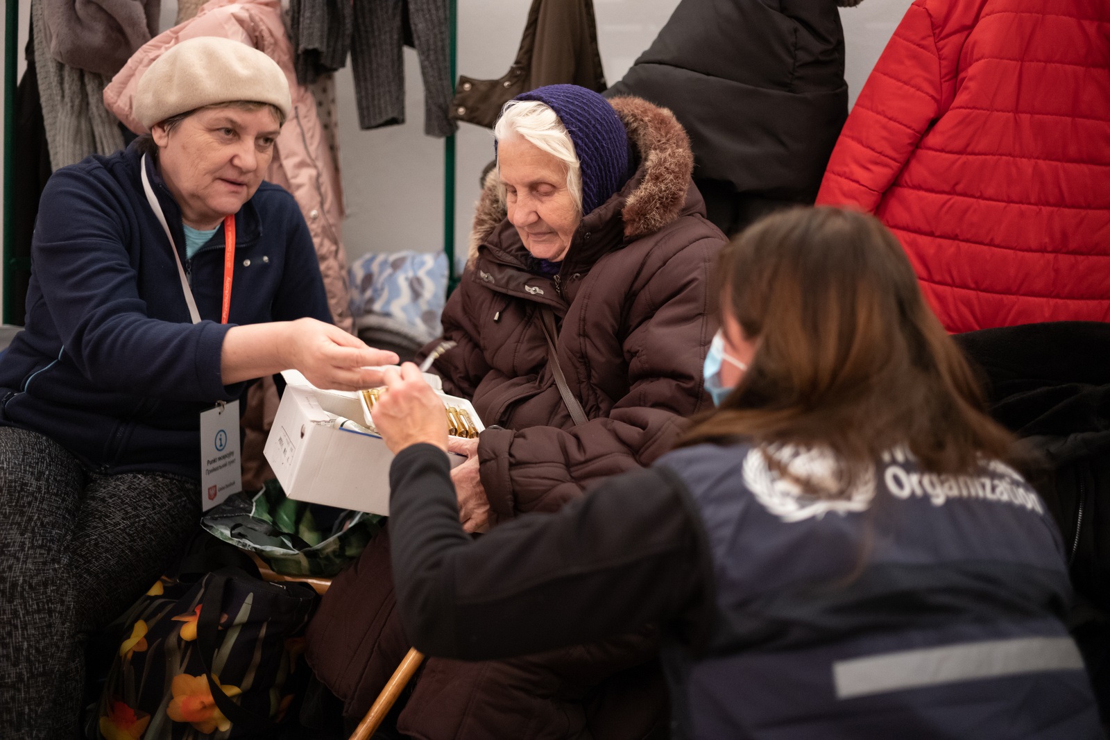 Ukraine_WHO_Hospital_Bombshelter_crop WHO worker in a basement wiith older women who have had to leave their homes,