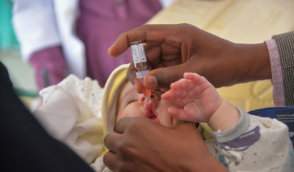 Baby receives vaccine drops in mouth