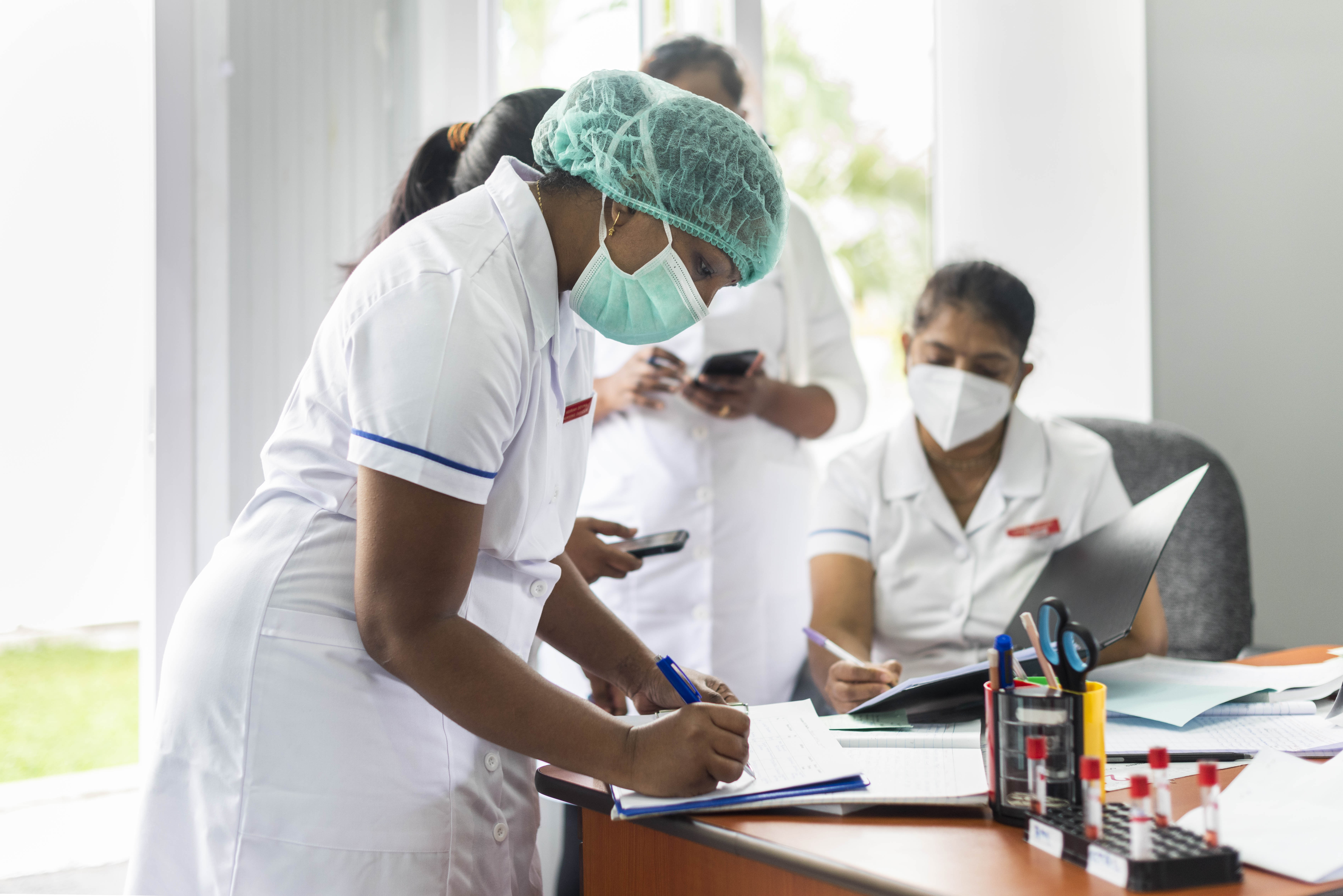 Health worker fills in paperwork
