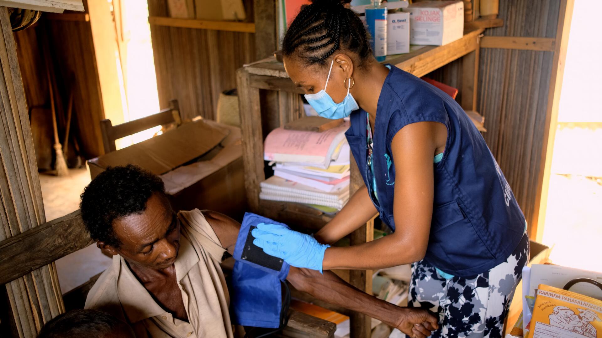 A nurse take the blood pressure of a patient