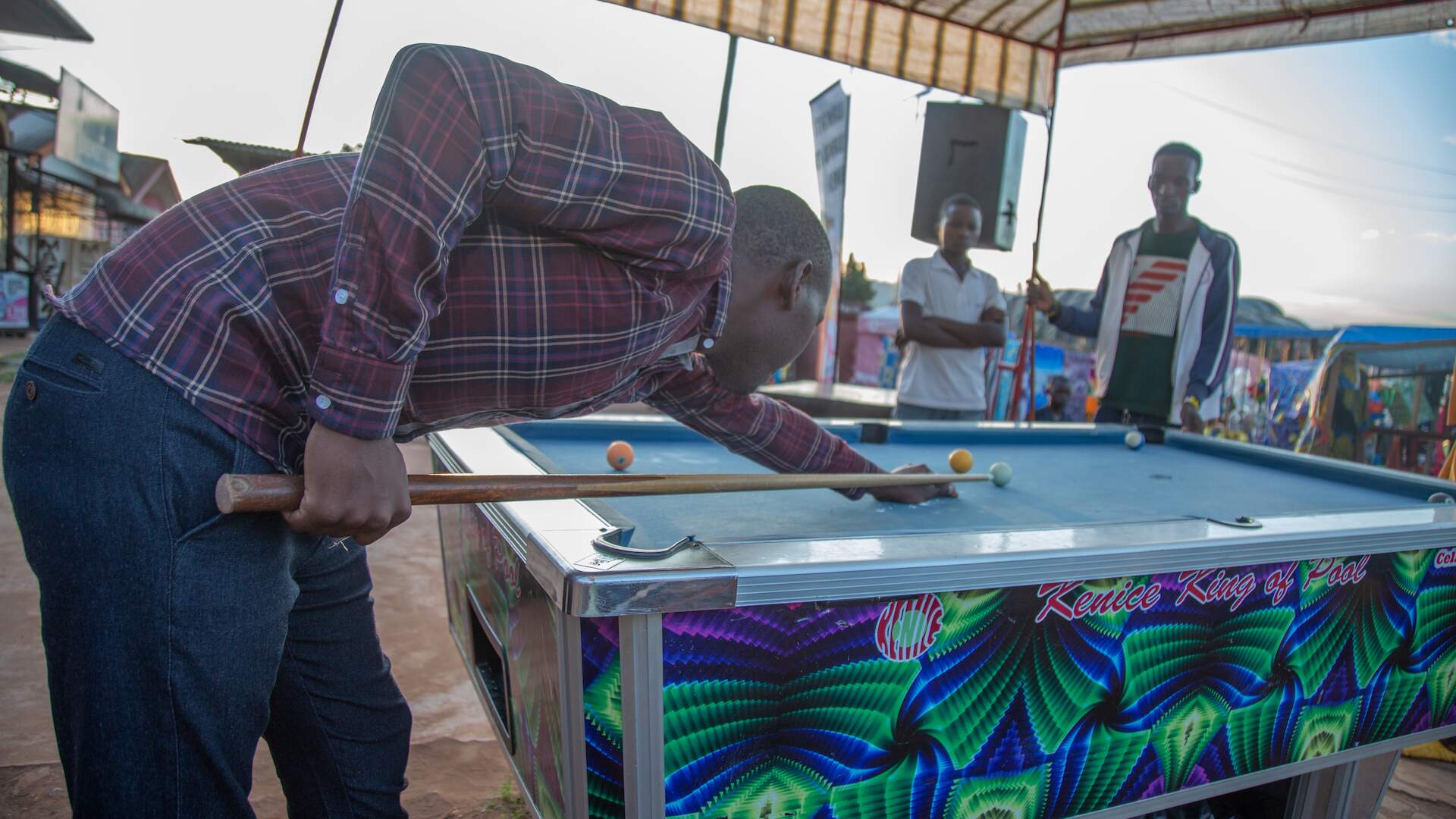 A man plays pool with friends
