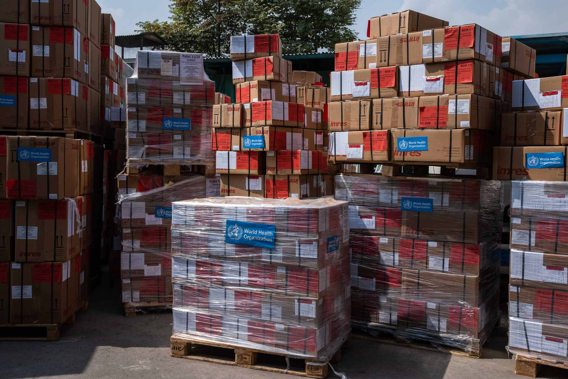 Warehouse pallets of WHO health supplies ready to be loaded on trucks for dispatch to heath facilities