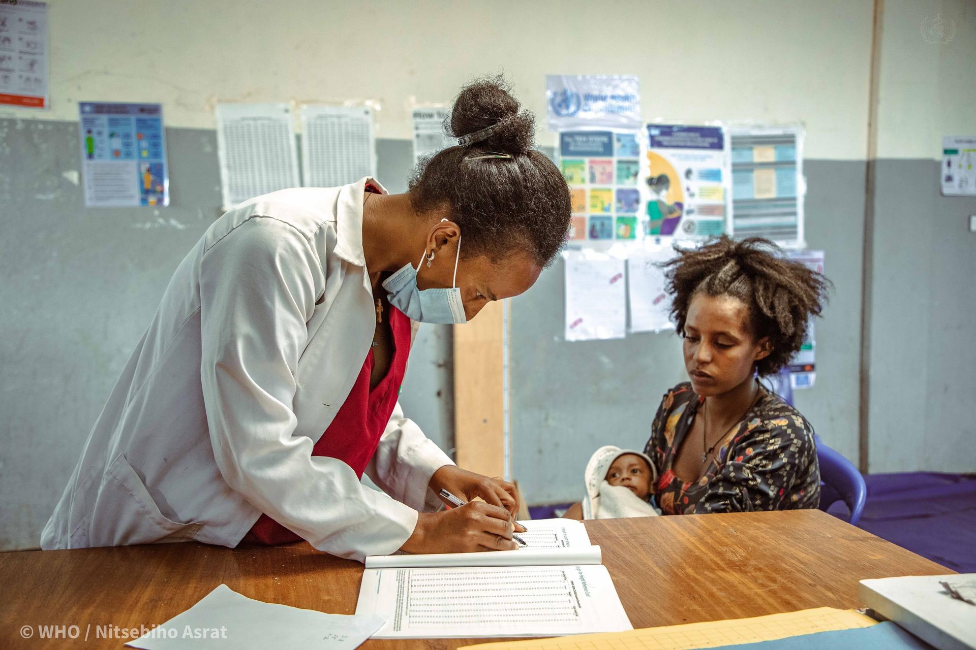 A nurse in the nutrition stabilization centre at Mehoni Primary Hospital instructs a mother on how to feed her malnourished child