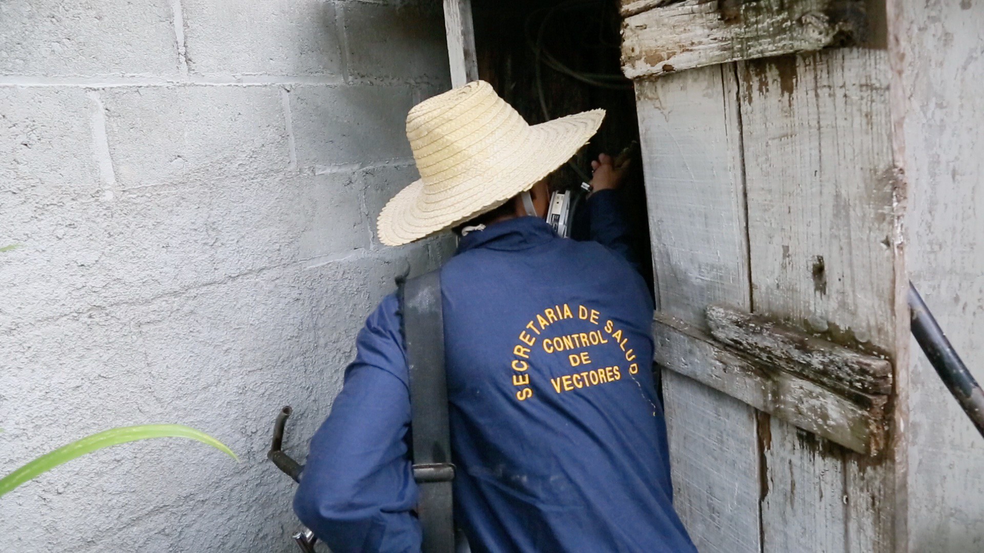 A health department employee is entering the home of a family
