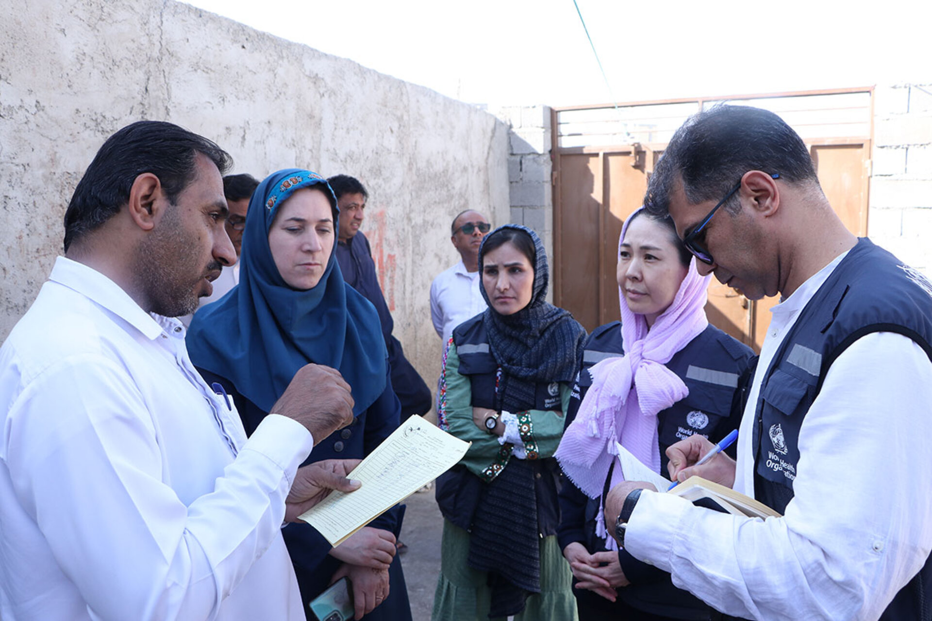 W.H.O staff discuss with locals