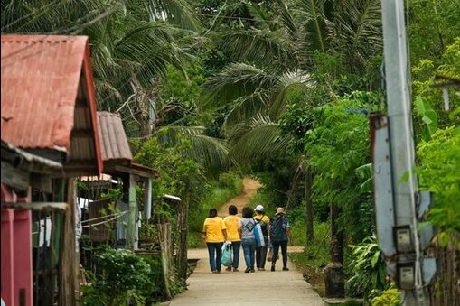 WHO staff and civil society organization (People in Need) walk by village for COVID-19 vaccination uptake increase amongst vulnerable groups