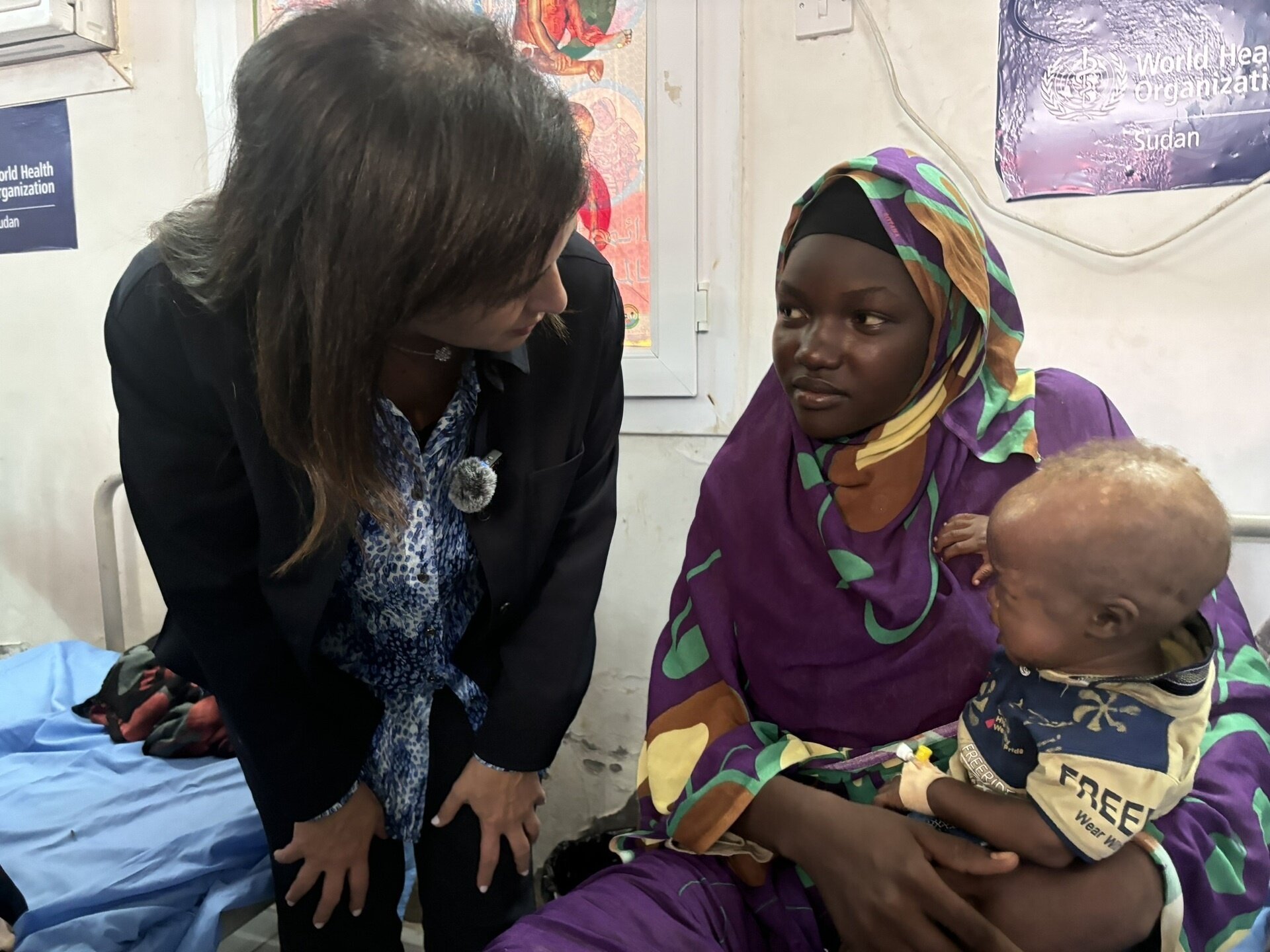 Regional Director with mother and child in nutrition stabilization centre
