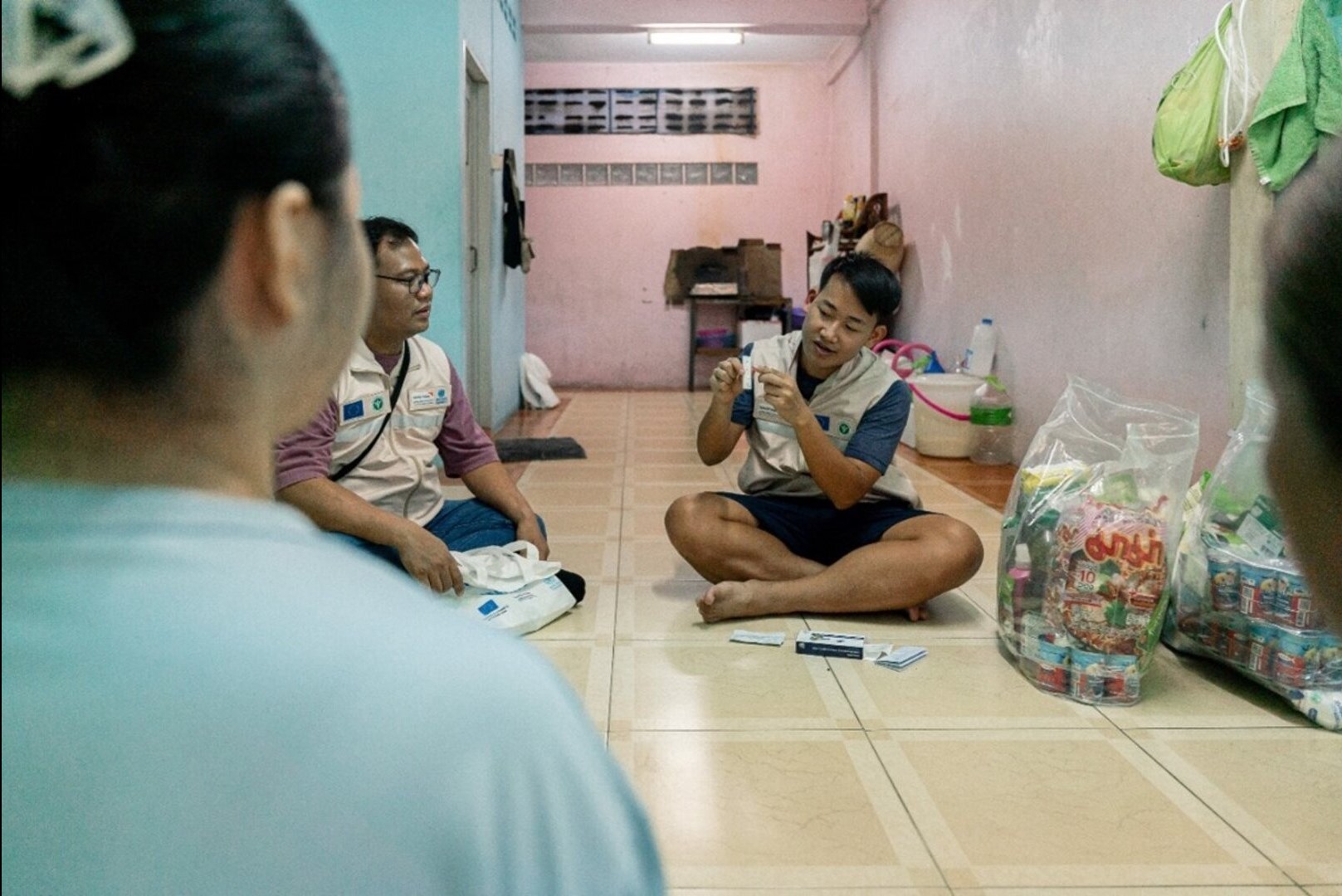 Migrant health volunteers give an ATK (Antigen Testing Kit) demonstration at a beneficiary home