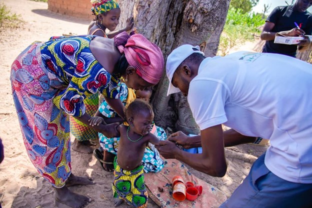 An eligible child receiving a vaccine during an immunization campaign.