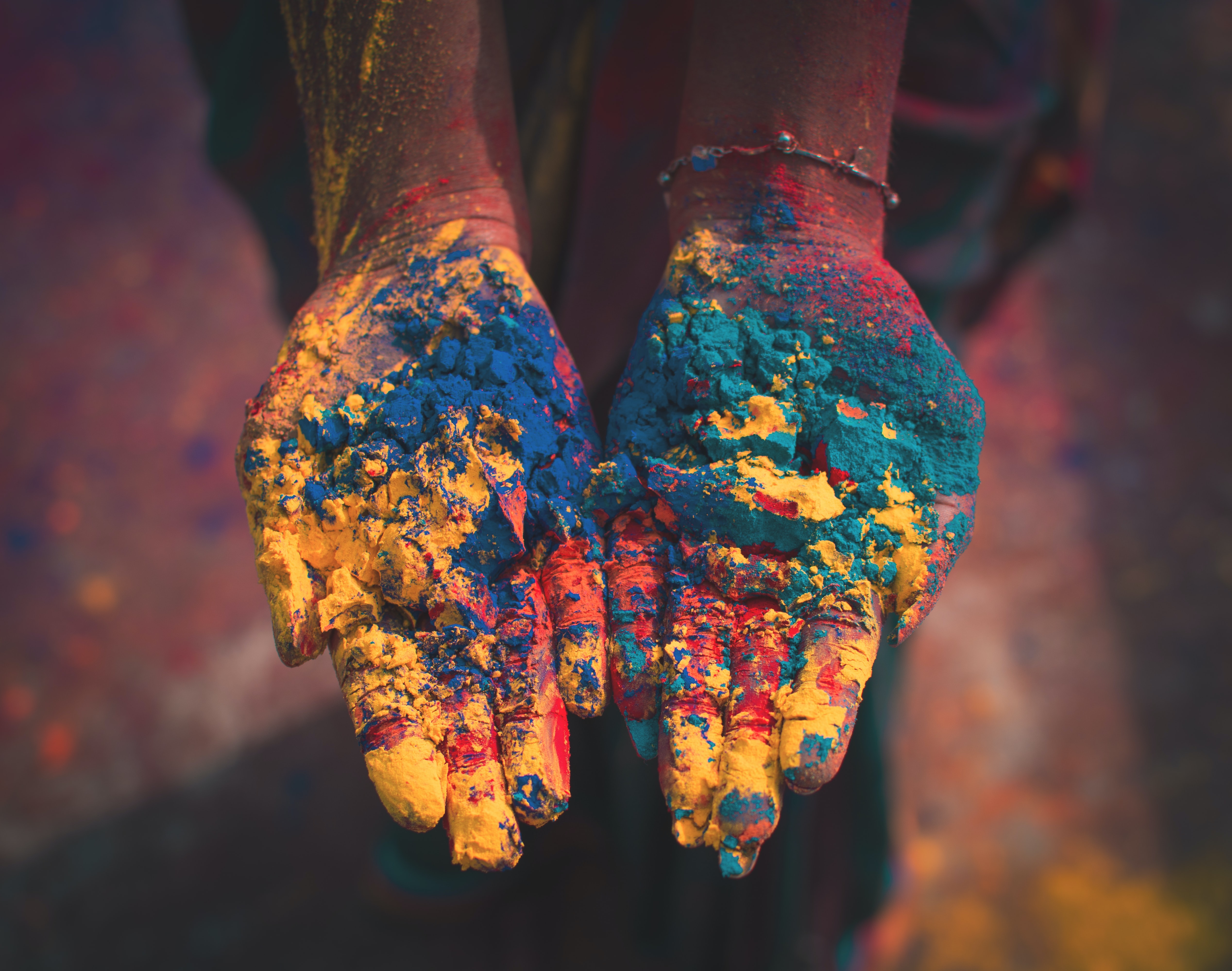 The Color of India - closeup photo of person holding color soils