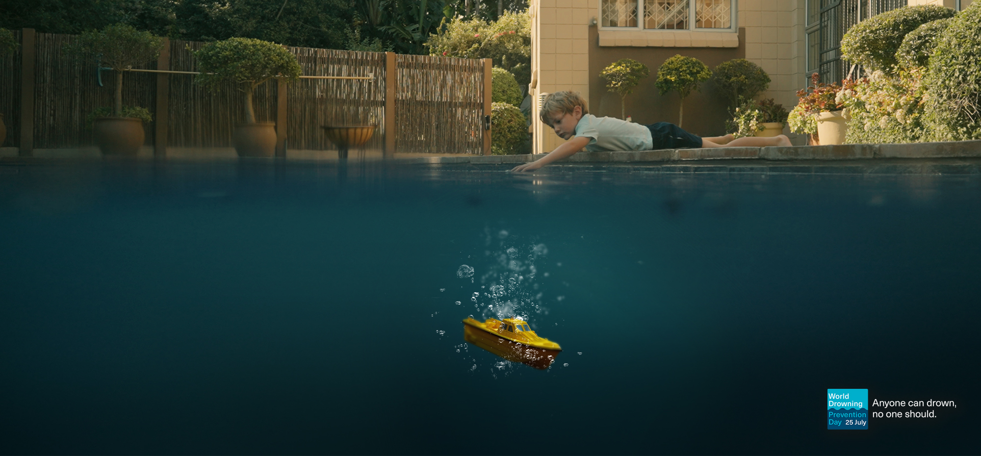 Child playing beside a pool