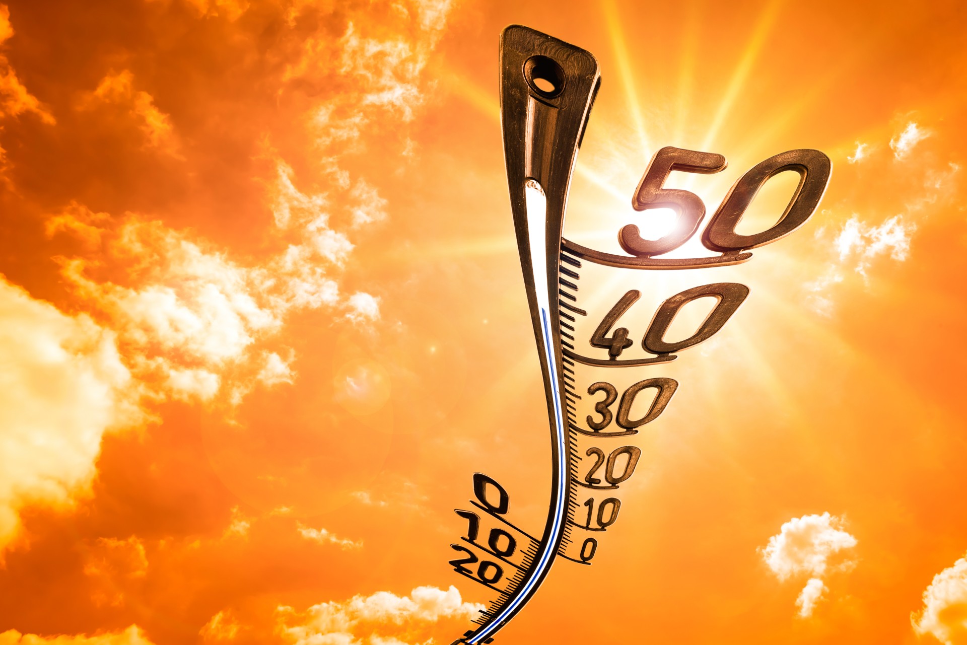 thermometer on orange sky background