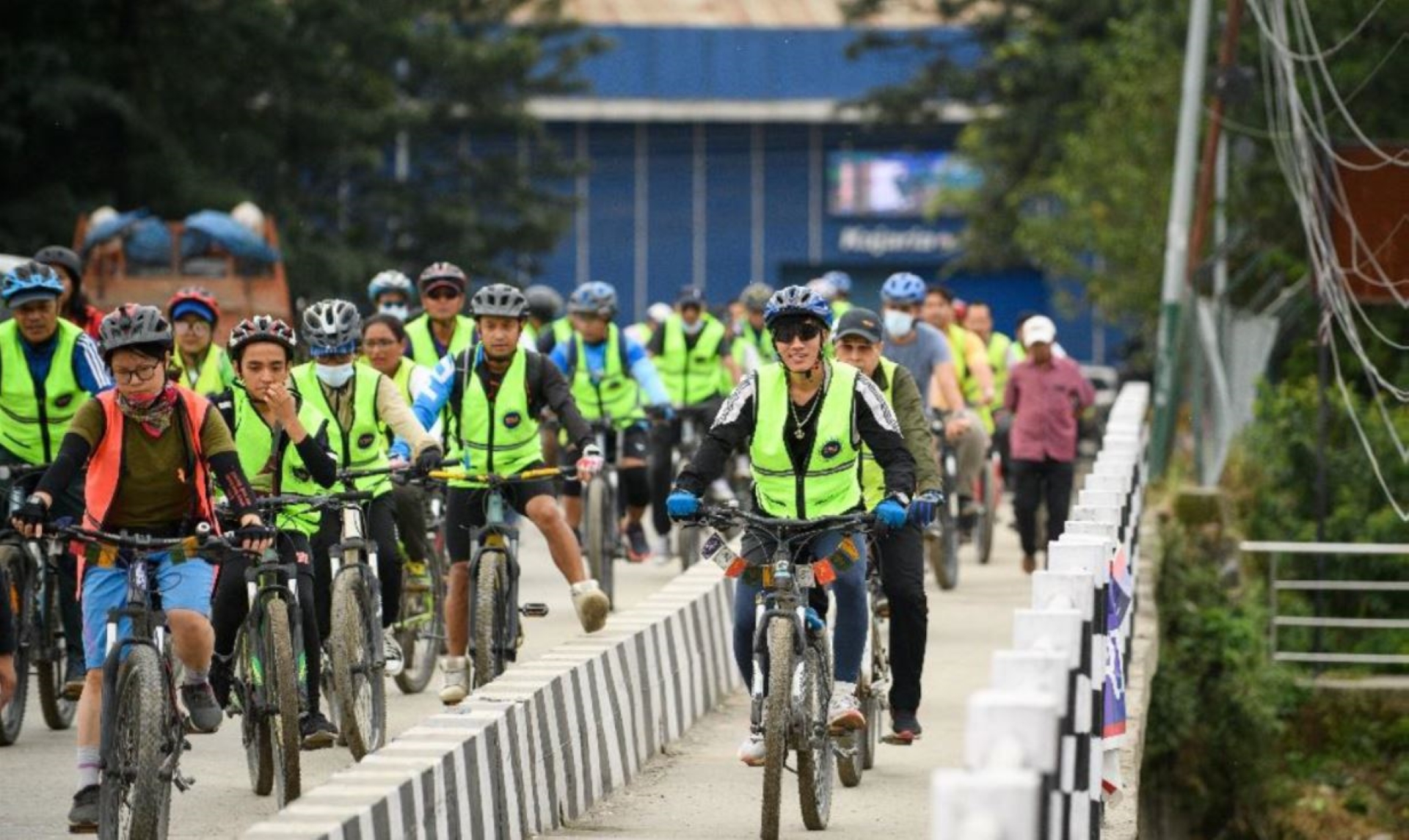 People cycling across a bridge