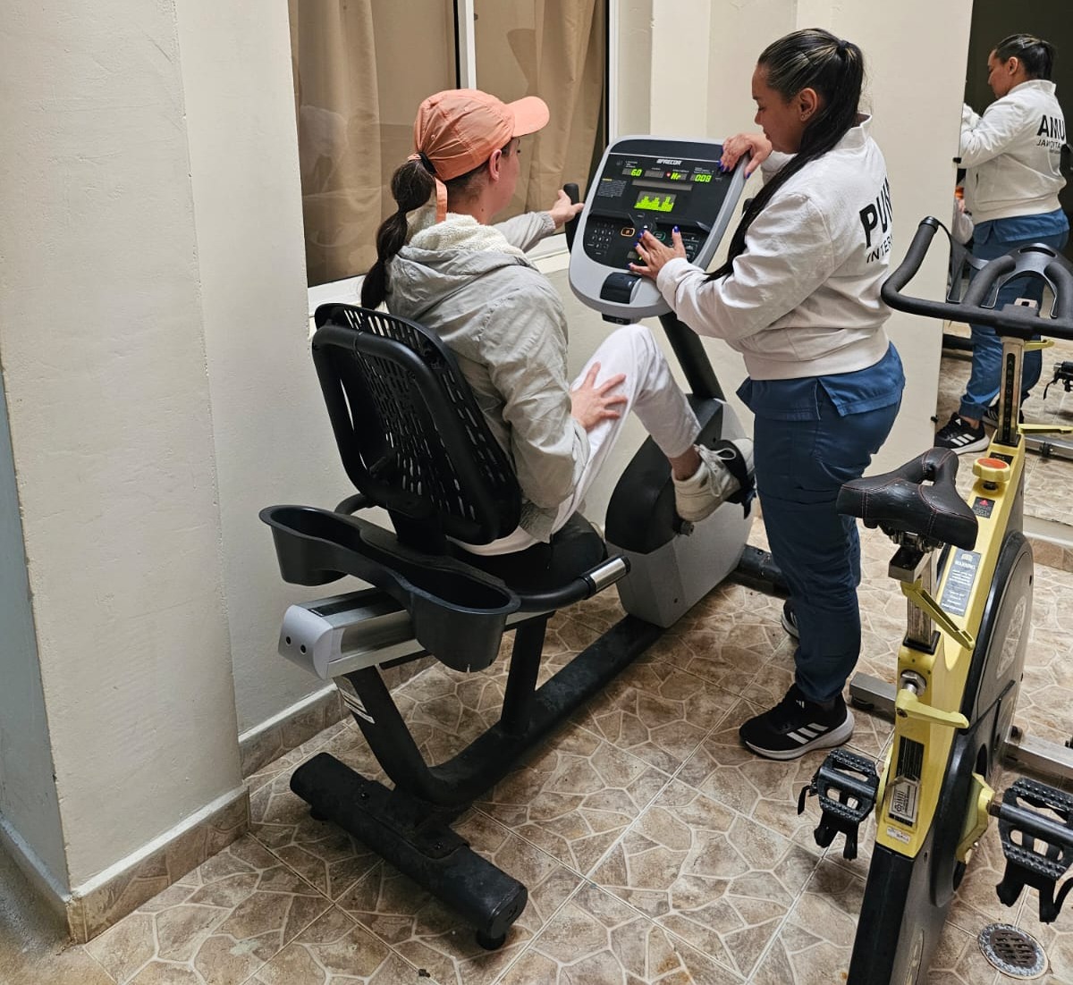 Yeliza during a session with her physio on a static bicycle