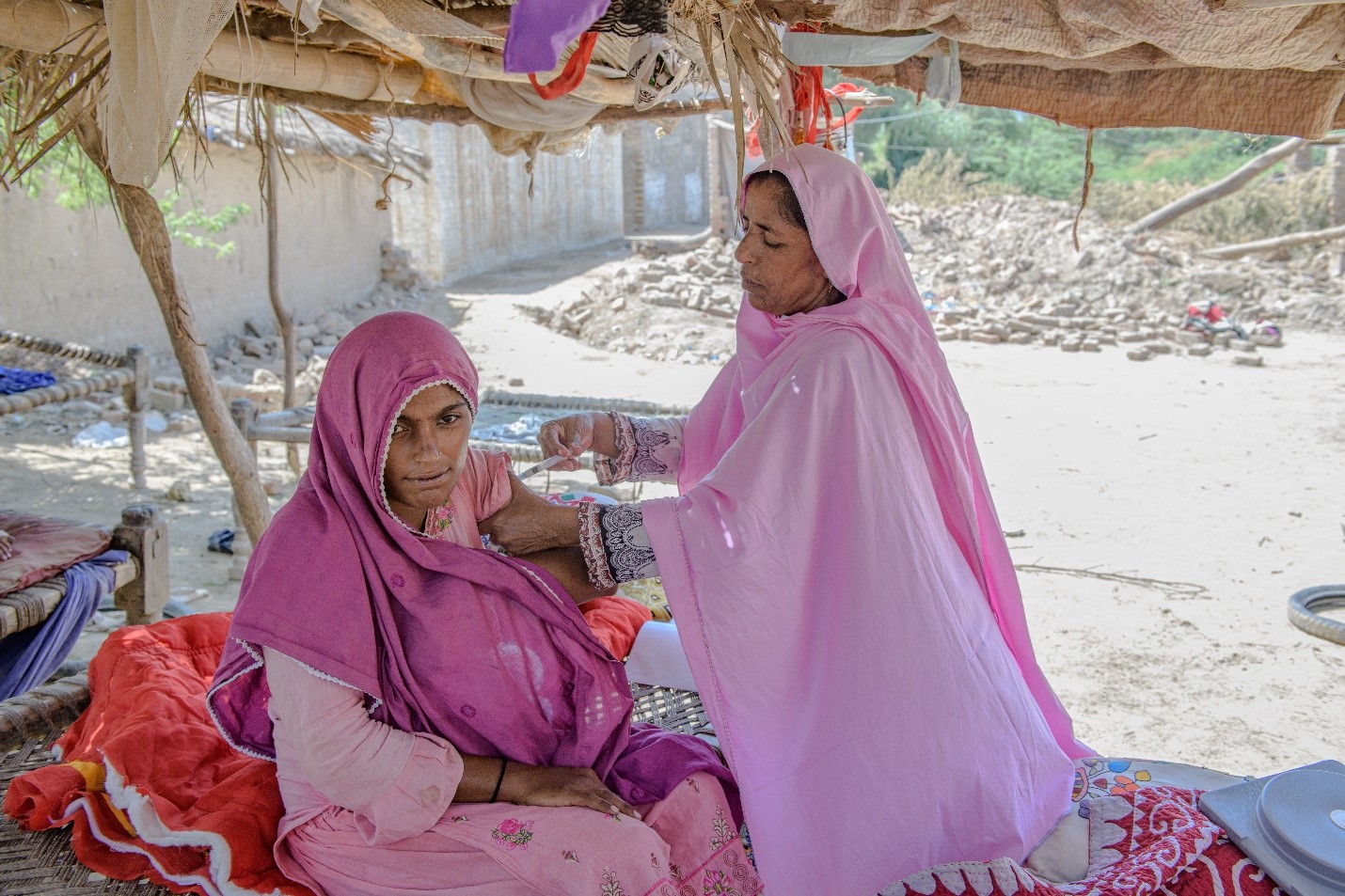 Close-up photo describing a health worker administering an injection