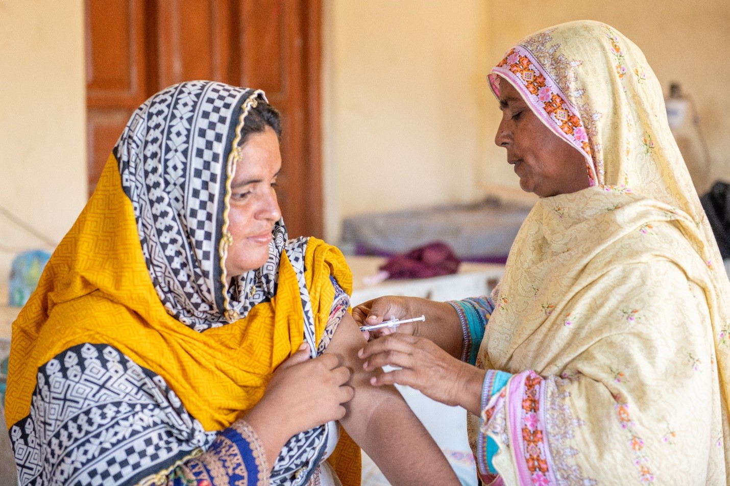 Close-up image of a health worker administering a vaccine