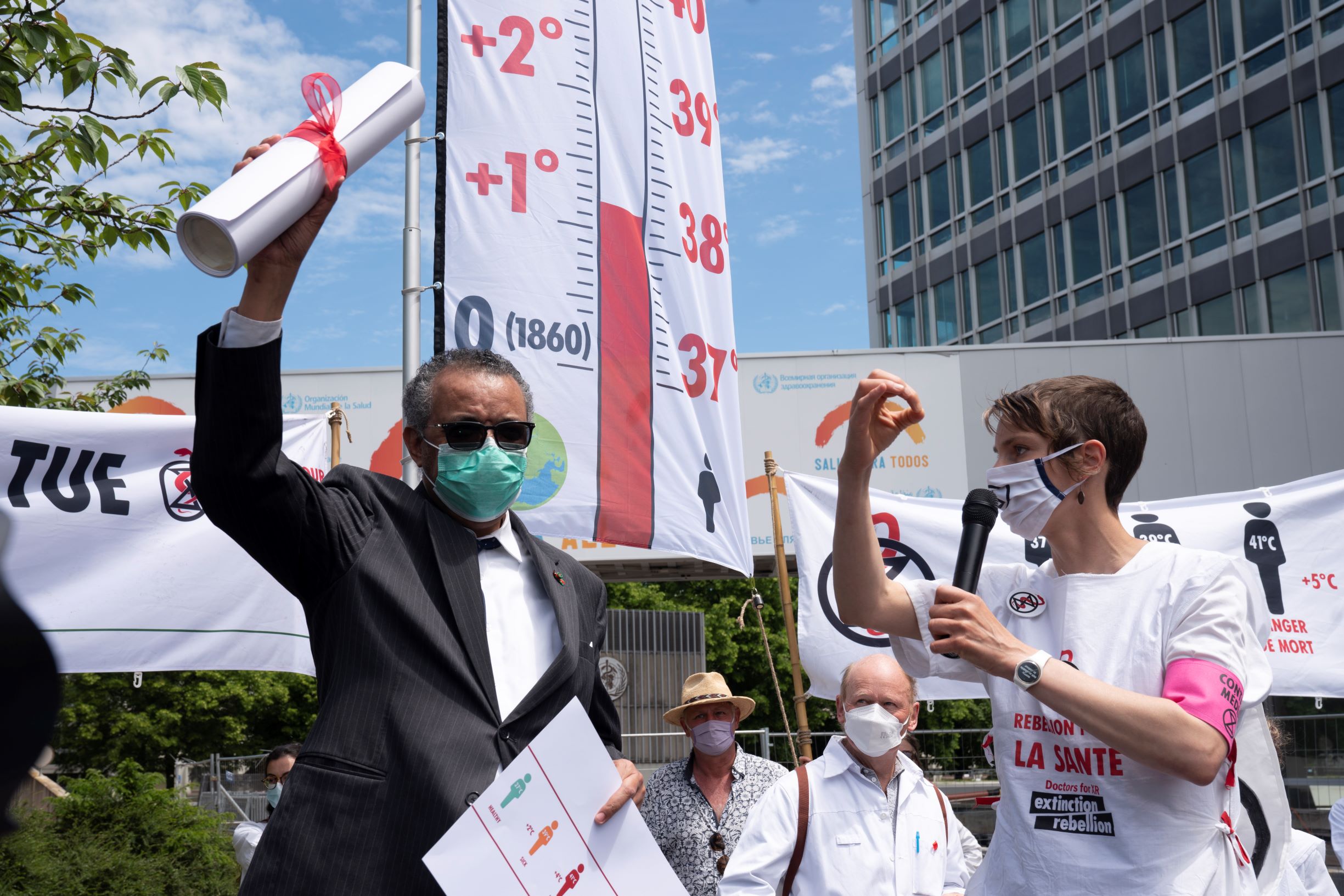 WHO Director-General Dr Tedros with health care workers calling for more ambitious climate action