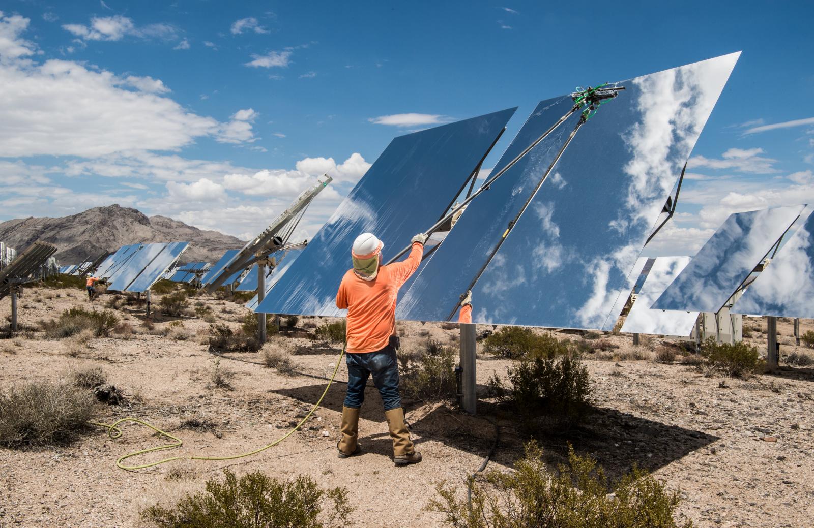 Laborer cleaning a solar panel