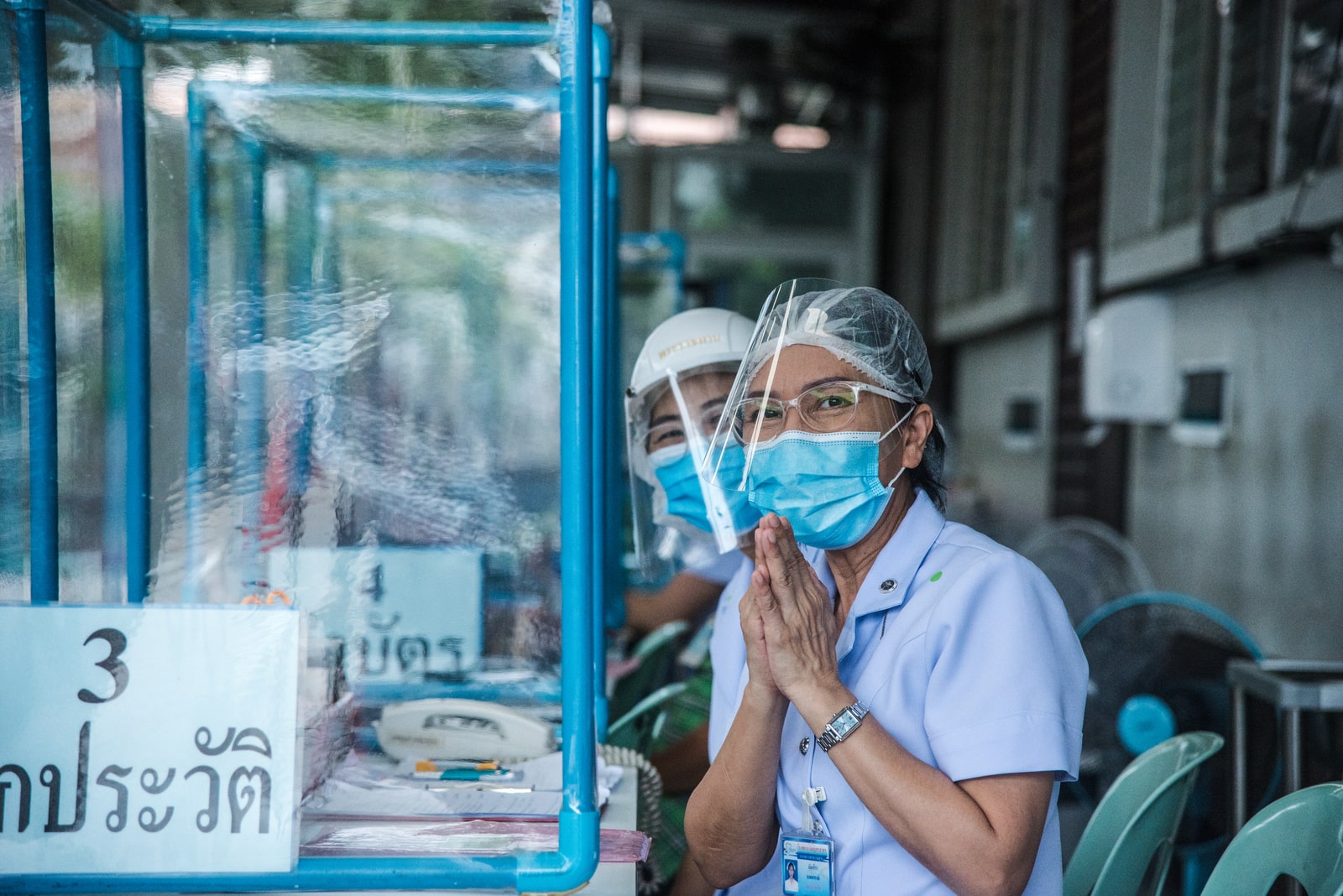 Nurses greet visitors at the clinic set up at Samut Sakhon Hospital to treat people with suspected COVID-19 symptoms.