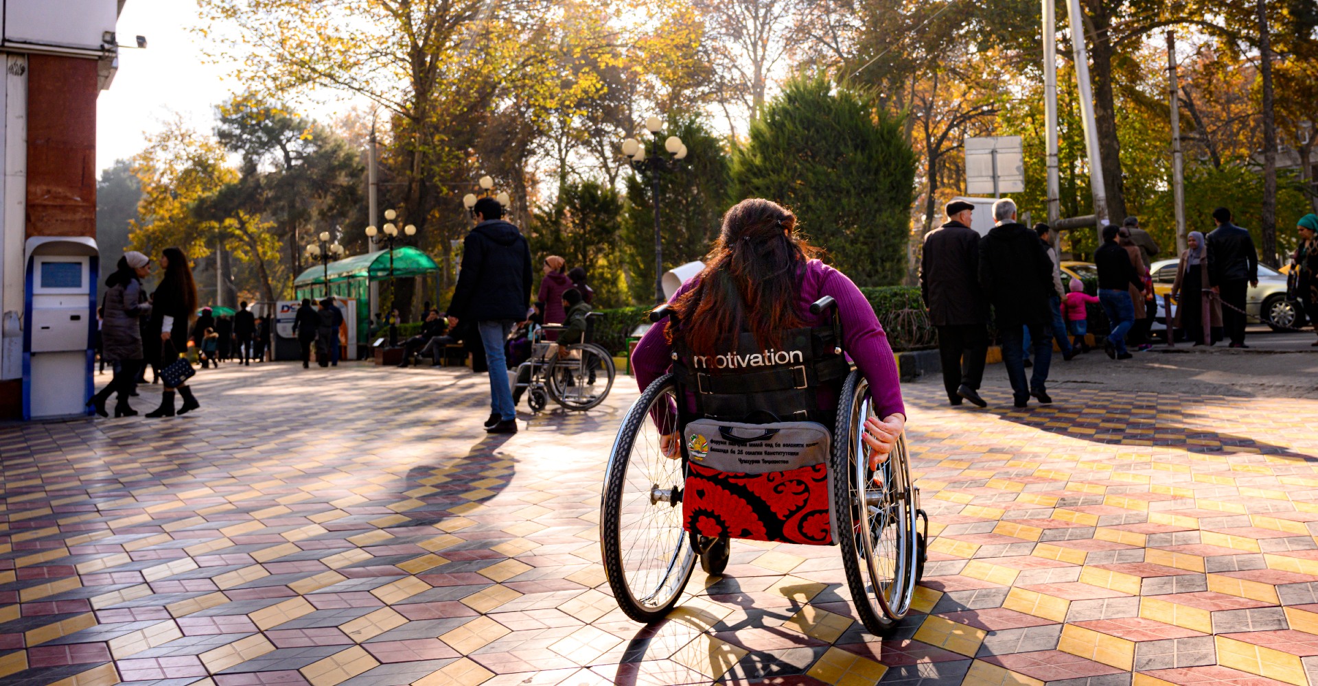 Woman in wheelchair on a pedestrian street.