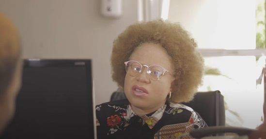 Woman wearing glasses looking at a computer screen