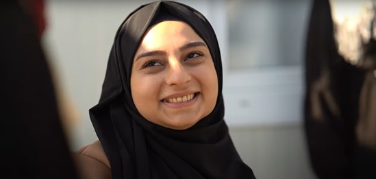 A person wearing a black head scarf