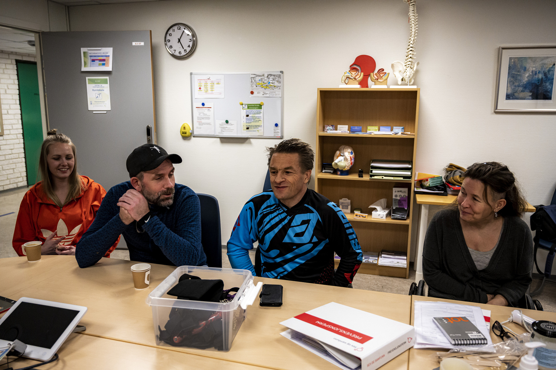 2 females and 2 males sitting around a table in discussion