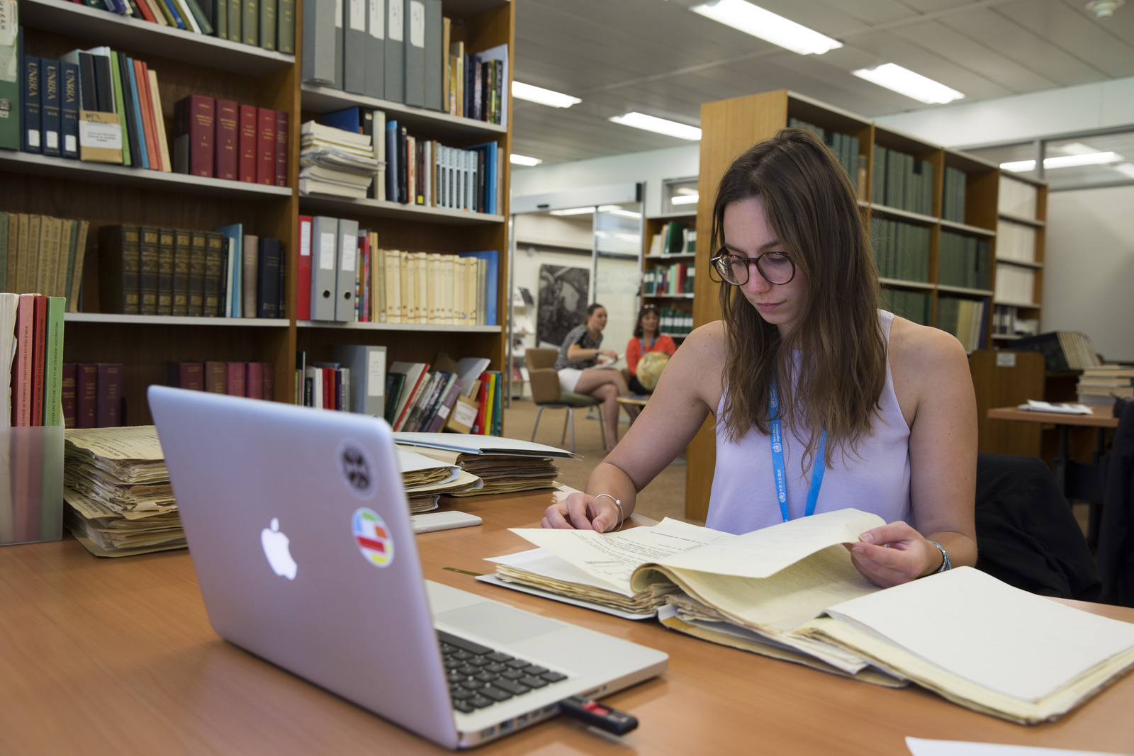 student in a library reading book