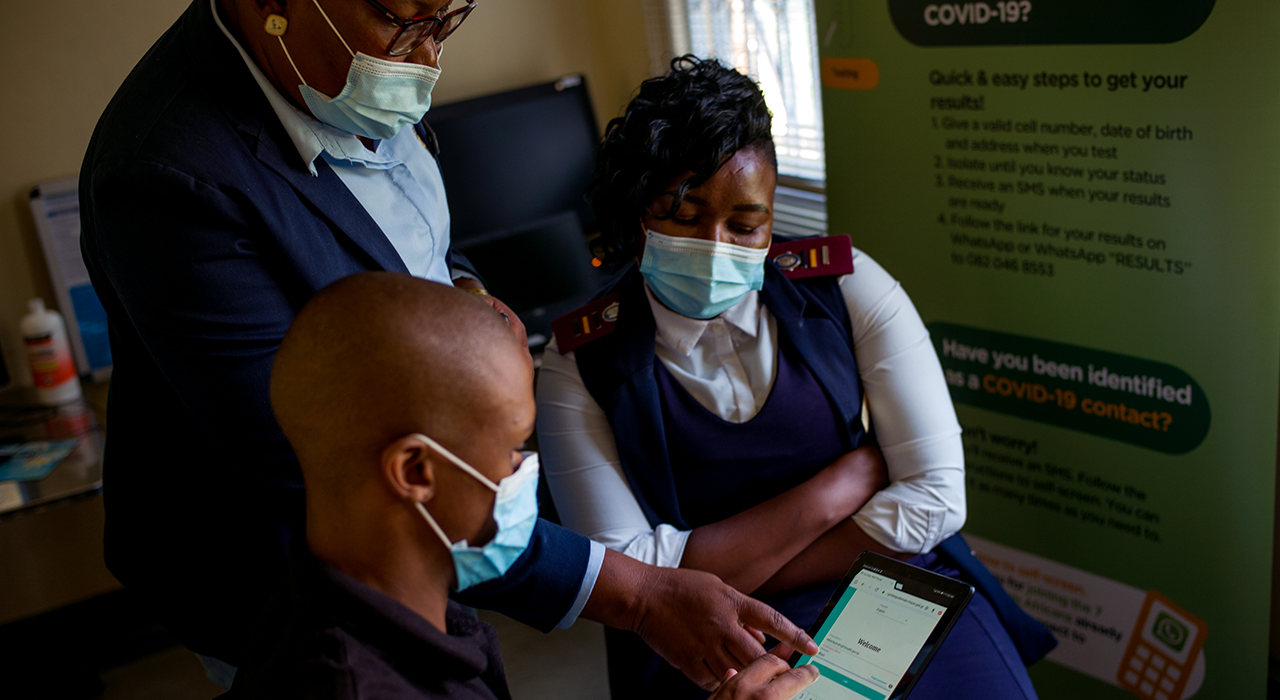 At a COVID-19 call centre in Sasolburg, South Africa, head of data capture Tshidiso Keemme, data analyst Dihlare Mthimkulu and nurse Puteletso Lekotjolo view Go.Data on a tablet.