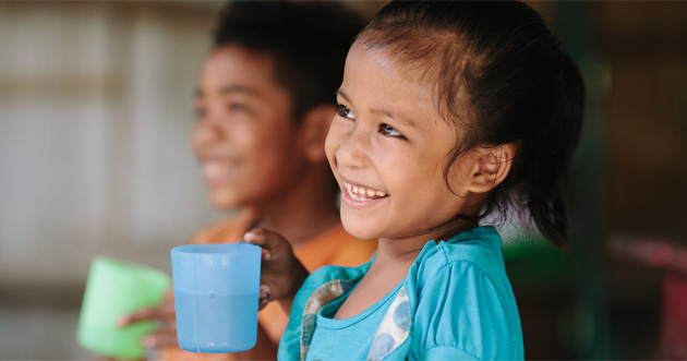 Girl holding a glass of water