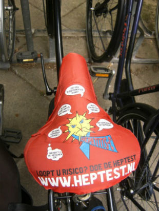 A close-up of a red cover for a bike seat that raises awareness of the need for hepatitis testing in the Netherlands.