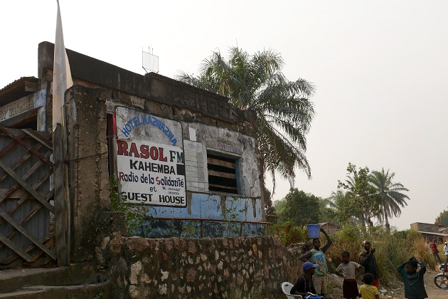 A small crowd assembles outside a radio station.