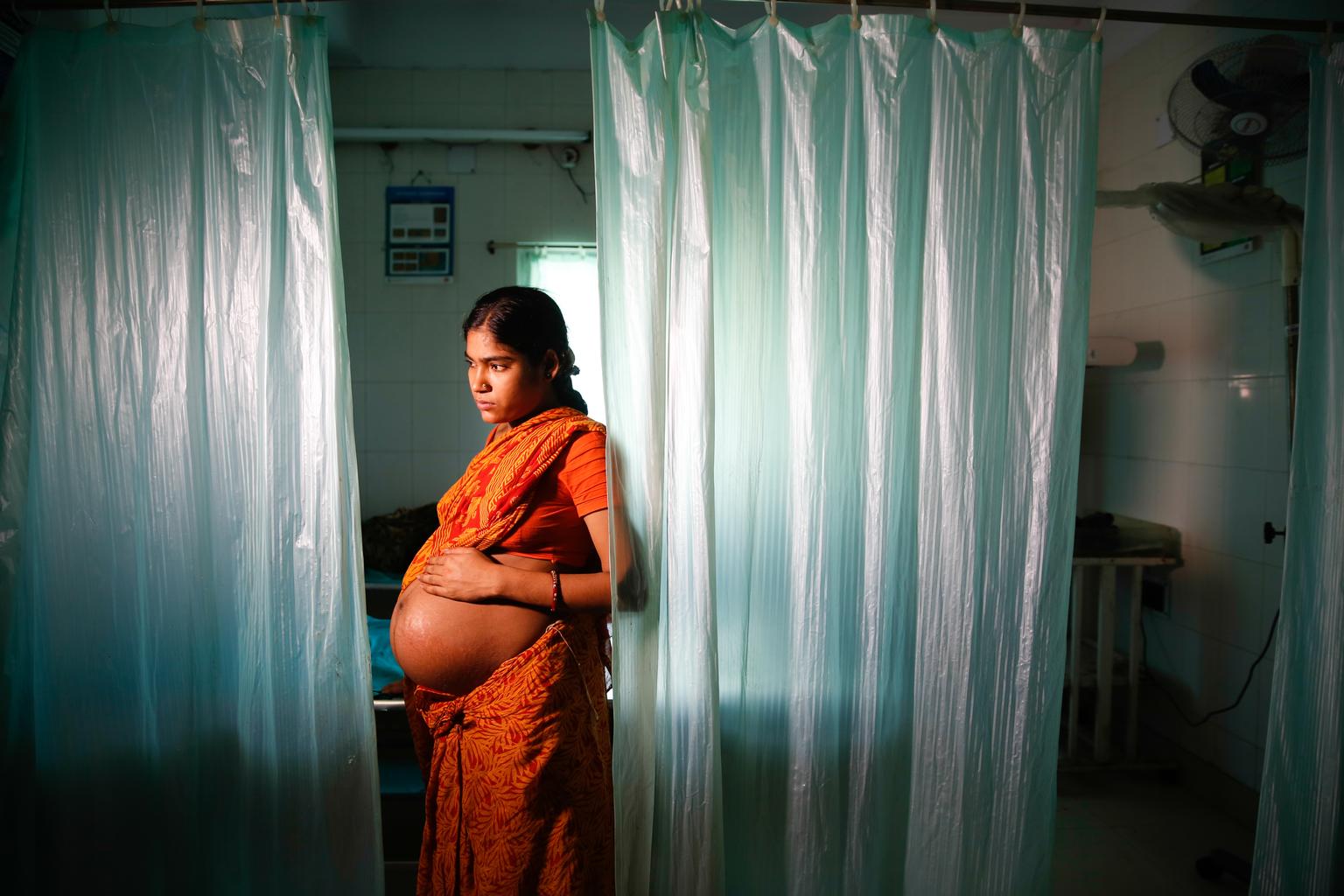 Pregnant woman with hands on her belly. 