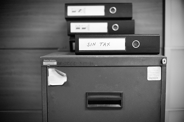 Filing cabinet with binders entitled ‘sin tax’.