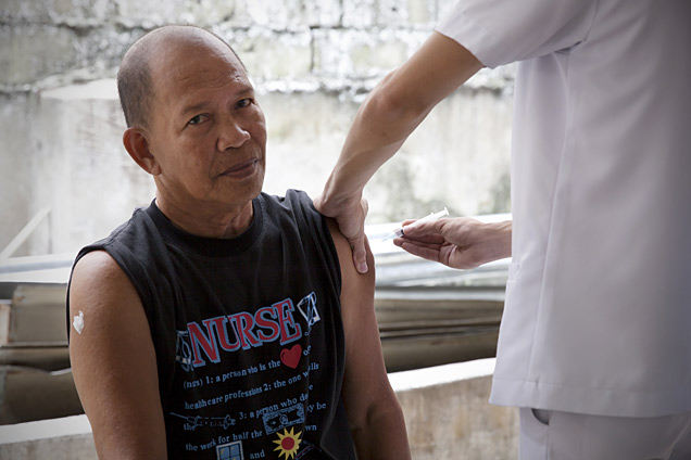 A patient receives a free flu vaccination in a health centre in Manila, Philippines.