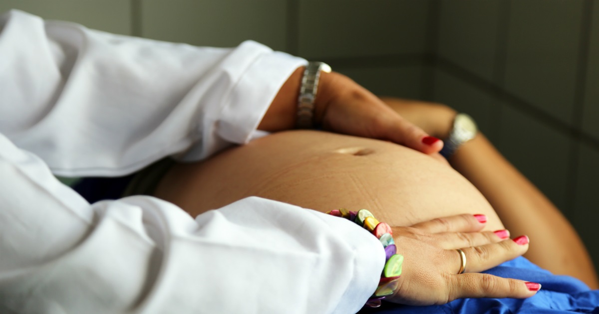 pregnancy Health physician examining a pregnant woman in Cuba