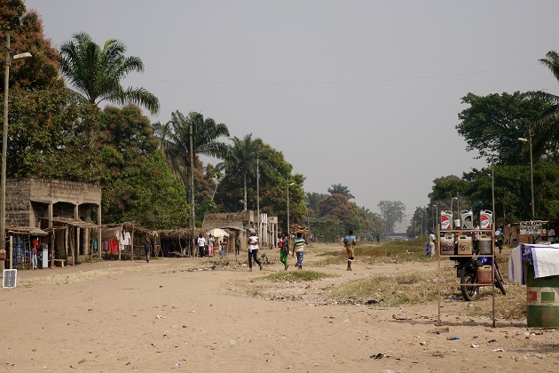 People cross a dirt road in Kwango, Democratic Republic of the Congo.