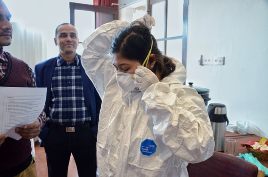 A nurse learning how to wear a hazmat suit at a WCO Nepal workshop; S. Amatya A nurse learning how to wear a hazmat suit at a WCO Nepal workshop; S. Amatya