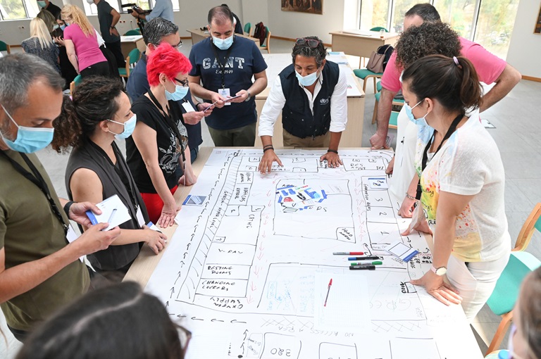 A group of people wearing face masks around a table