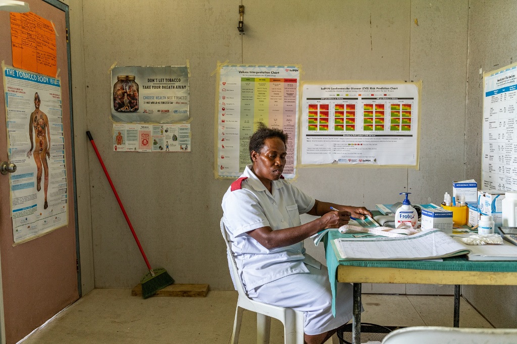 PEN programme Health worker sitting at her desk in the clinic