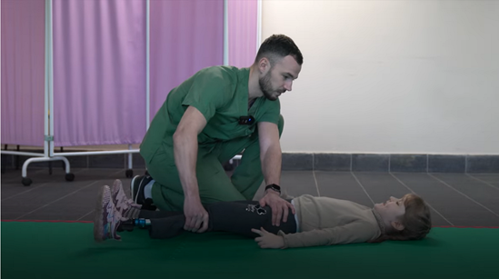 A child undergoing rehabilitation by a health professional