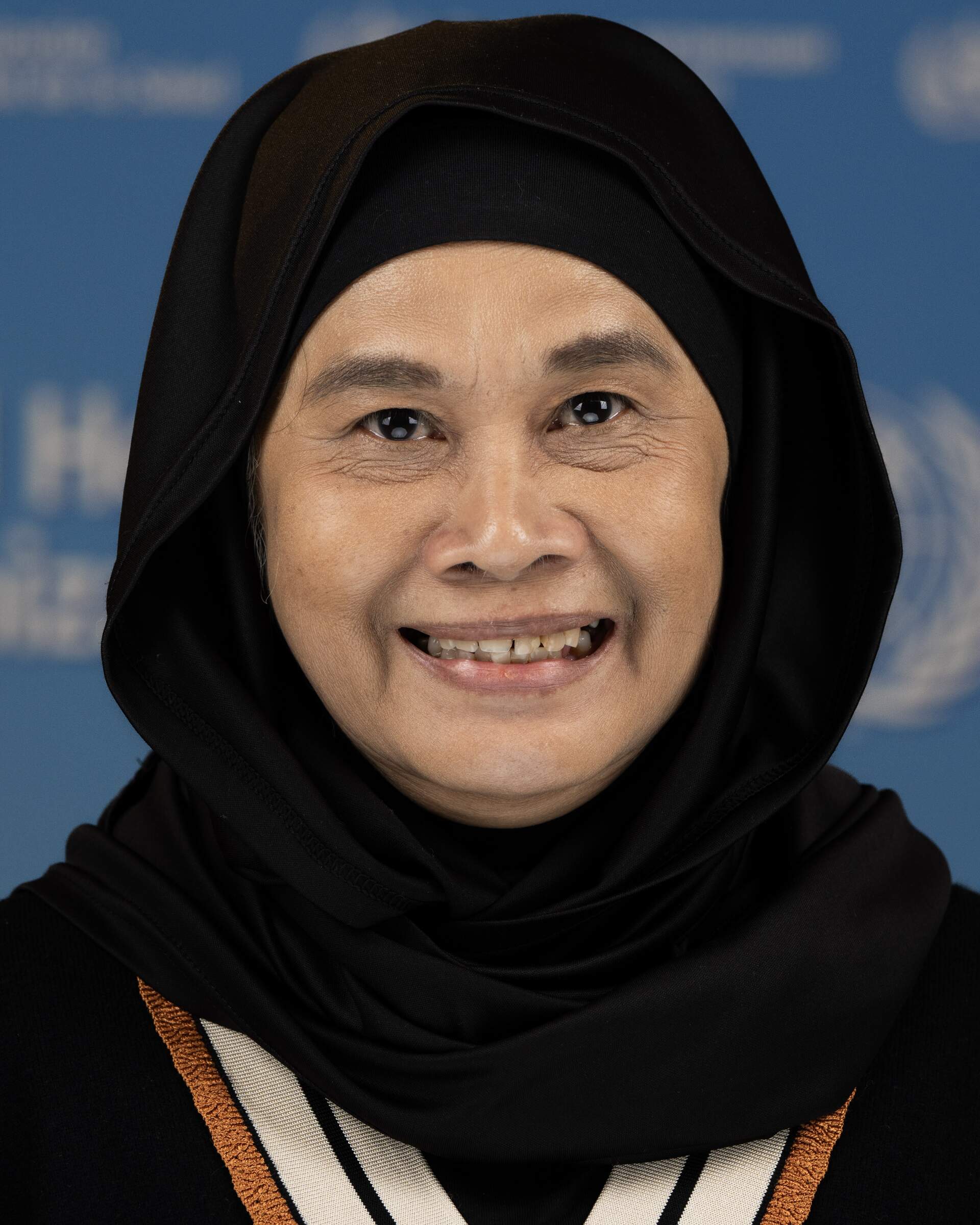 Portrait photo of a woman wearing a headscarf.