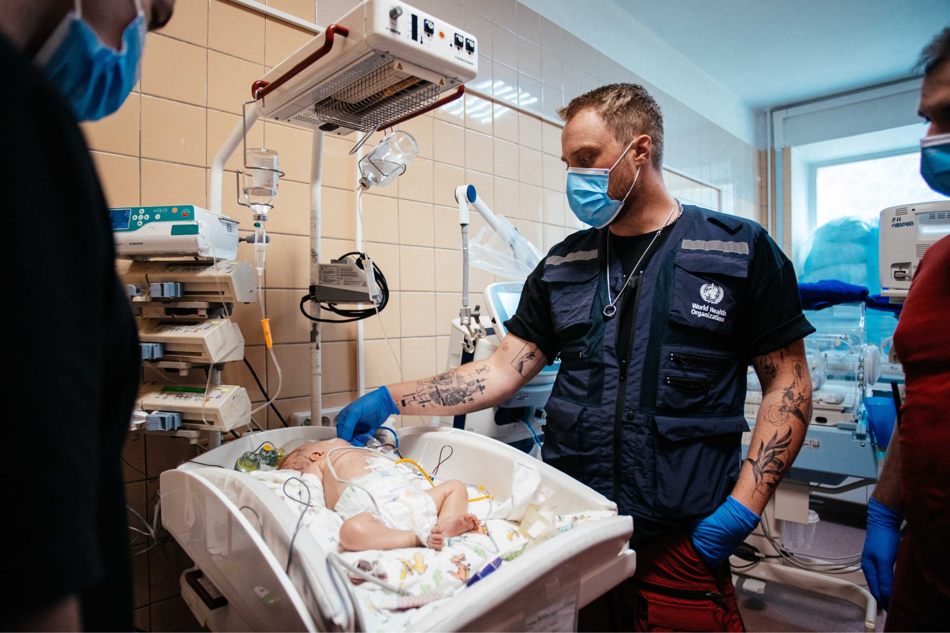 WHE 2025 Appeal featured appeal Ukraine A consultant wearing a WHO vest examining a 4-month-old child in a hospital.