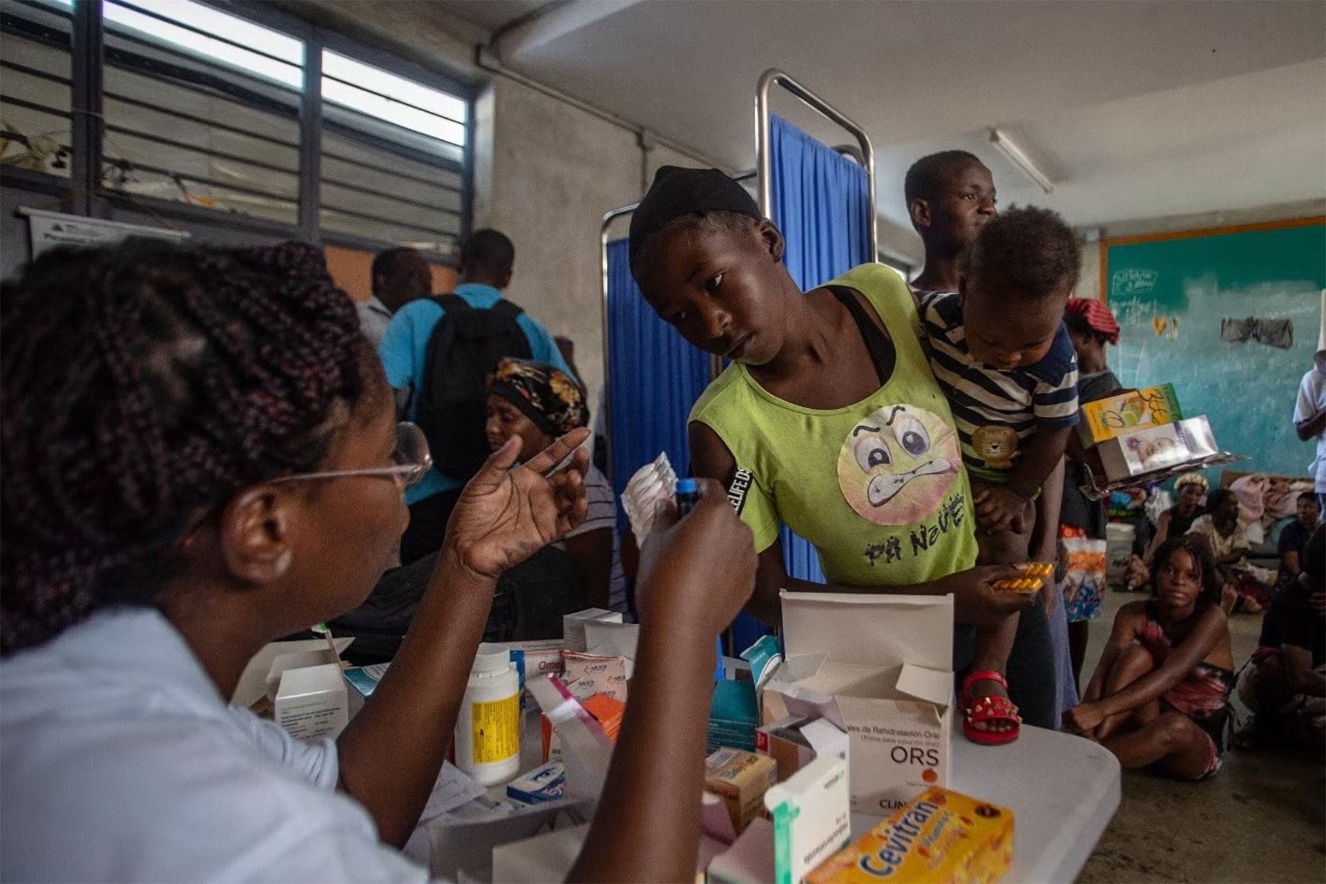 WHE 2025 Appeal Impact in 2024 Haiti A person giving a blood sample to a child.